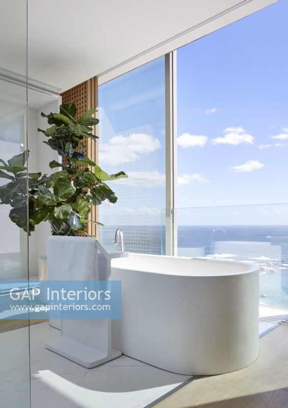 Freestanding contemporary bath with sea views 