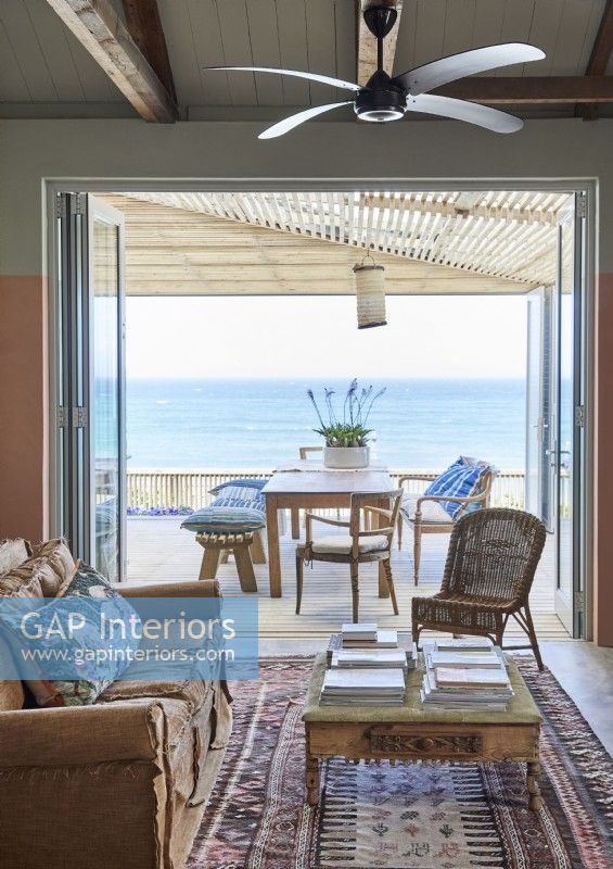 Living room with view to sea and furniture on terrace