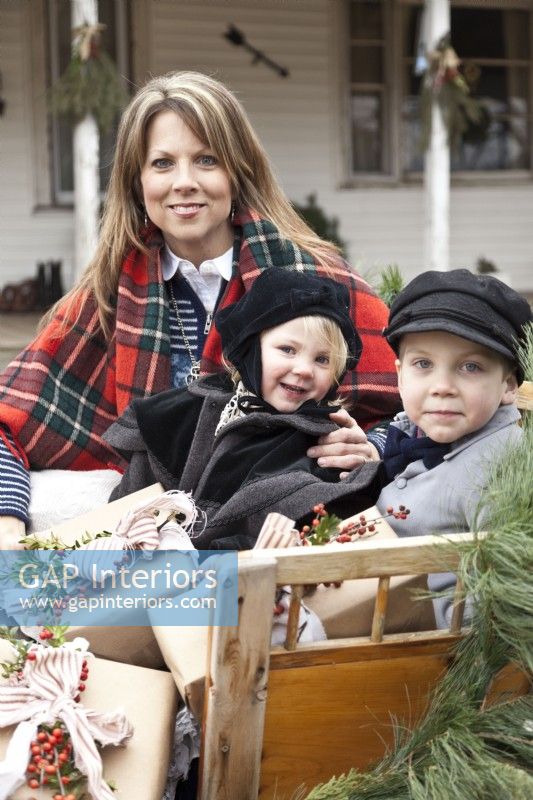 Mother and children getting ready to go on a Christmas sleigh ride