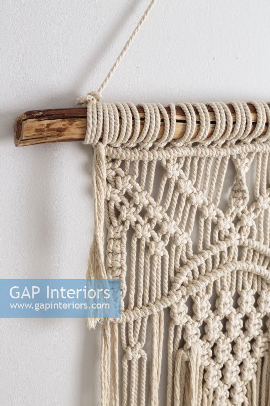 Handmade macrame hanging from a salvage piece of wood.
