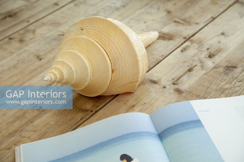 Shells and books about the coast  keep the cottage location in focus throughout the spaces.