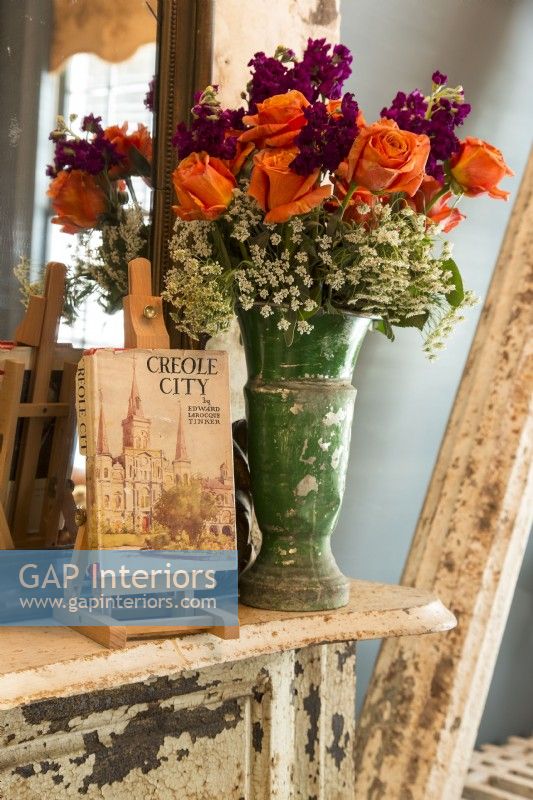 Renee is an avid gardener and reaps the benefits with colorful blooms.
A small easel displays  a vintage book about the old city of New Orleans. 