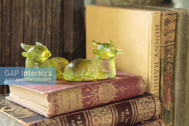 The quirky green glass â€œsacred cowâ€ paperweights were market treasures found on a trip to India. 