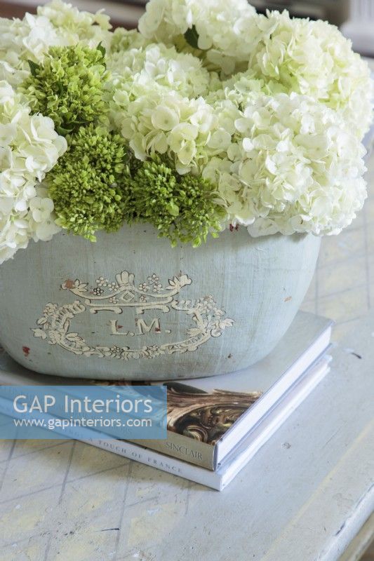 Details matter to Kathy who prefers to show off fresh cut blooms in unique containers, like in this antique French pot.