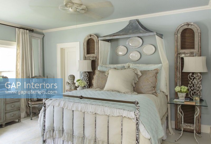 Kathy mixes wood pieces in a variety of natural finishes with metal ones that show a little age, and then ties everything together with a color scheme of gentle whites, dove gray and pale blue.  