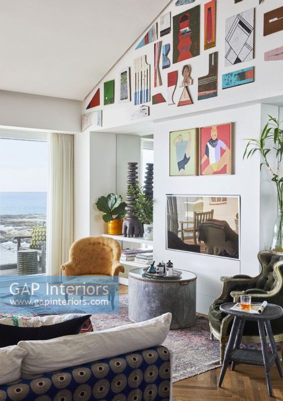 Display of colourful modern artwork on living room wall 
