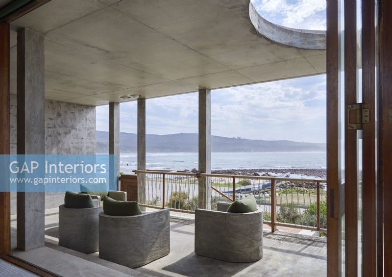 Concrete furniture on contemporary balcony with sea views