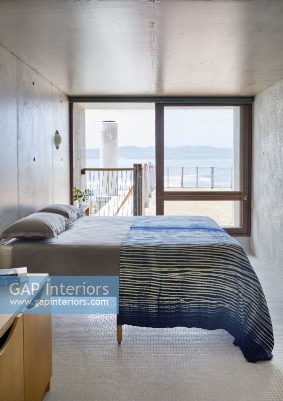 Simple concrete bedroom with sea views