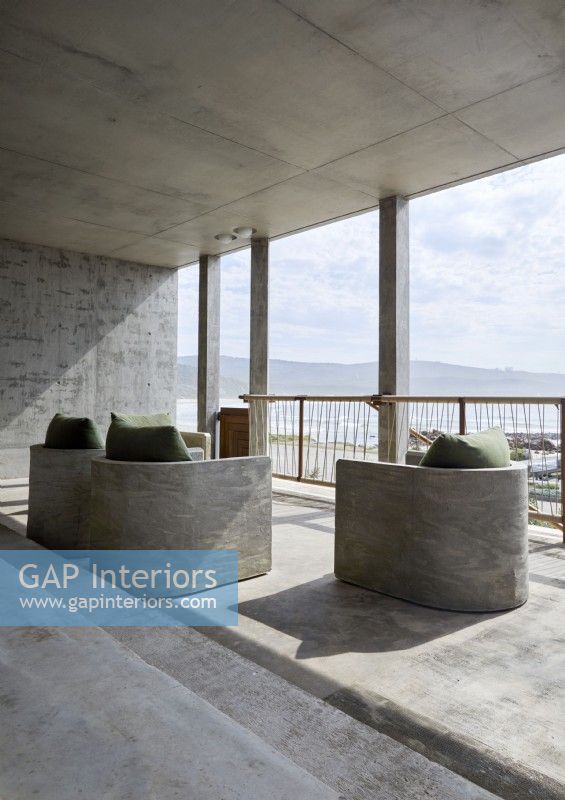Minimal concrete balcony with built in seats 