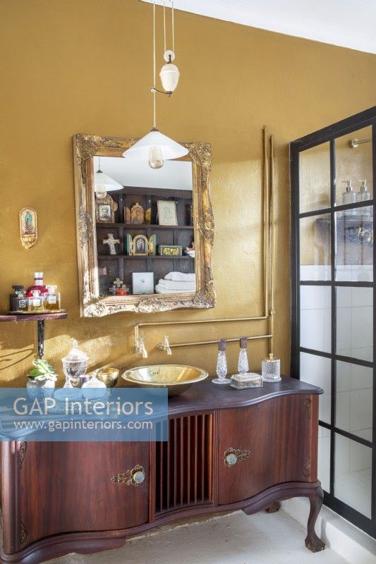 Bathroom with vintage cabinet vanity and gold walls