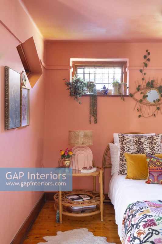 Bedroom with electic decor and pink walls