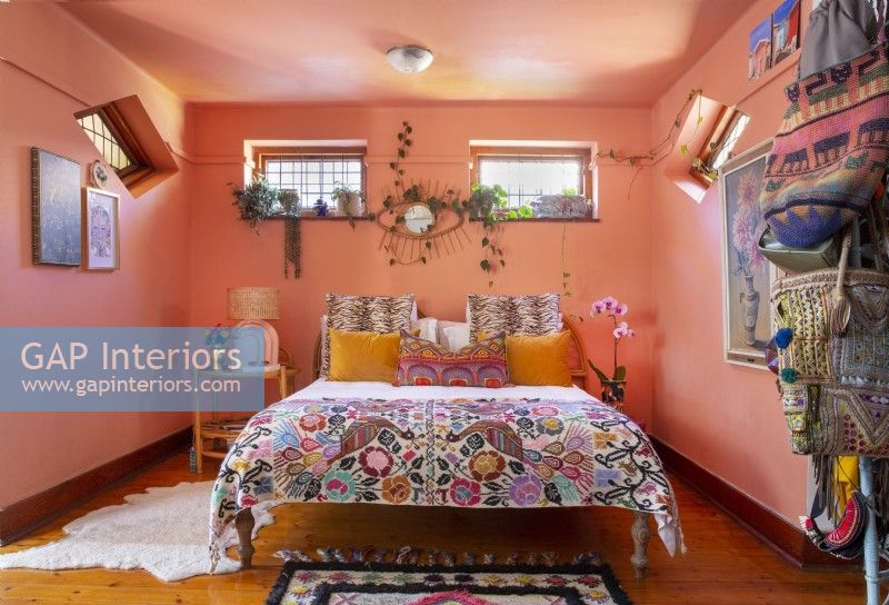 Bedroom with eclectic decor and pink walls