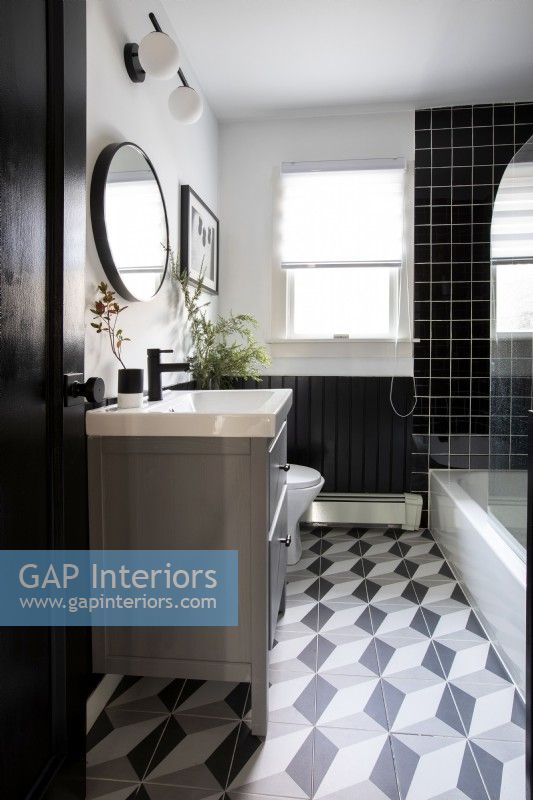 Modern bathroom with black and white tiles.