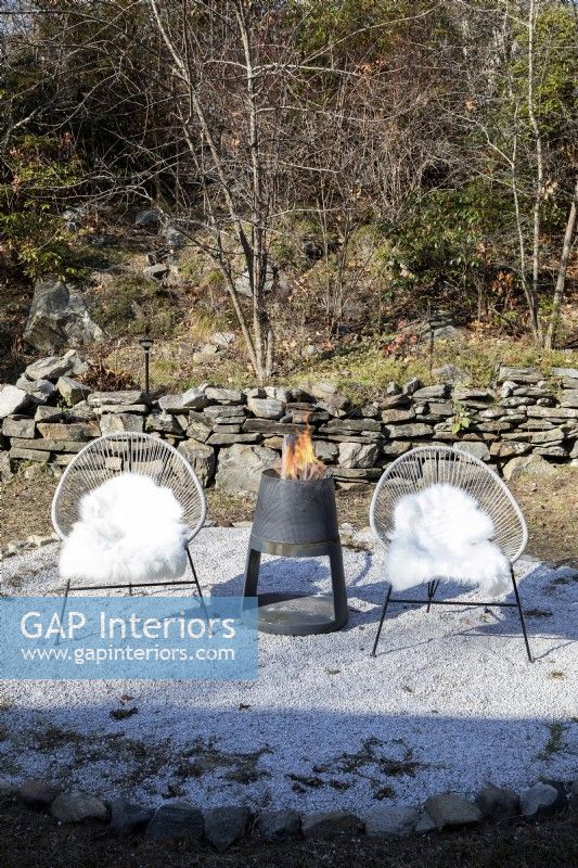 Outdoor seating with burning fire pit.