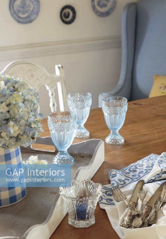 Blue hobnail goblets keep up with the dining room blue and white palette and patterns while paying tribute to Dawneâ€™s fondness for one of Franceâ€™s favorite country color combination.