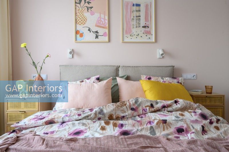 A feminine, pastel bedroom with lots of bedding