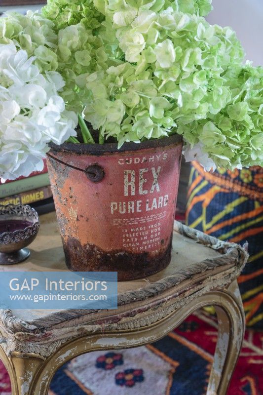 An old lard bucket makes a charming vessel for flowers.