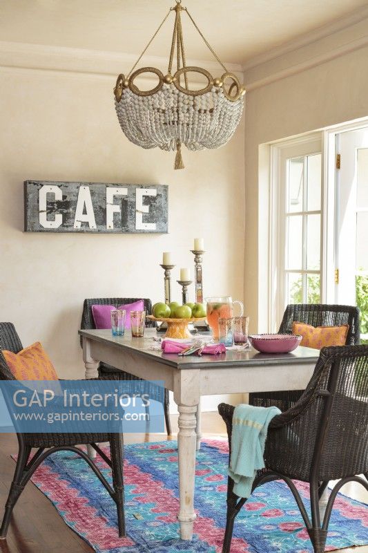 In the dining room, an exotic rug sets off the dark wicker chairs. By keeping things simple and livable, the Fidels have created a space that feels real, not contrived.