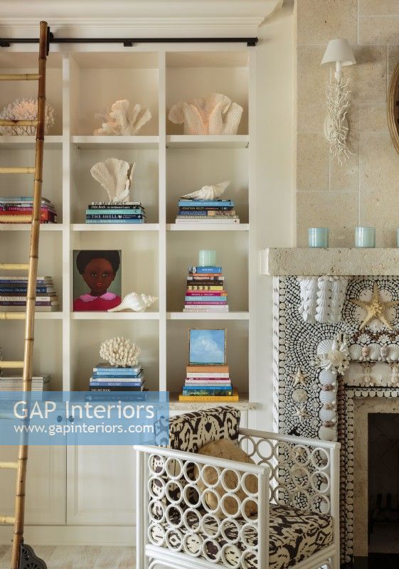 Built-in bookshelves keep favorite tones and a collection of shells neatly organized.