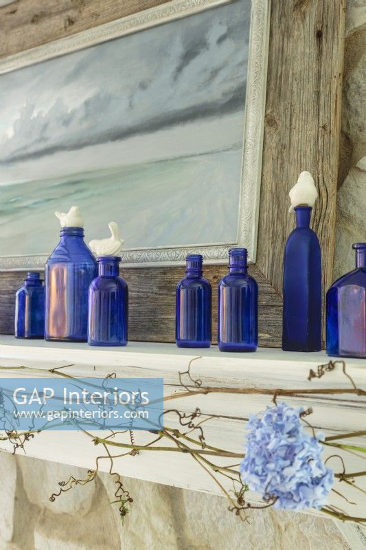 In one form or another, nature is always present in Erin's home Here, vintage cobalt bottle are topped with tiny ceramic birds.