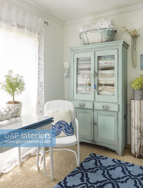 An antique hutch provides stylish storage for Erin's collection of vintage textiles.