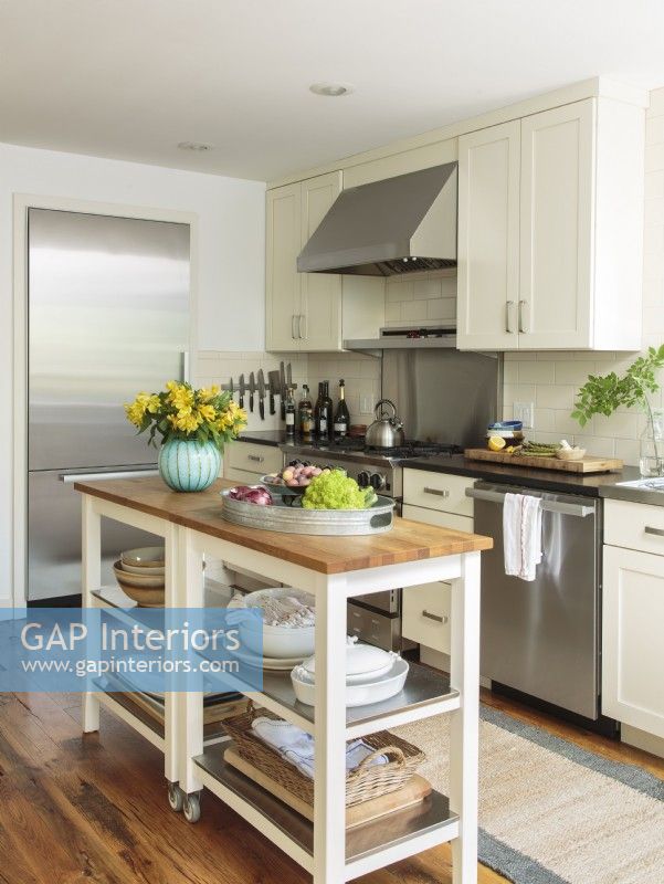 A butcher-block utility table with casters doubles as a rolling kitchen island and keeps everything within easy reach. 