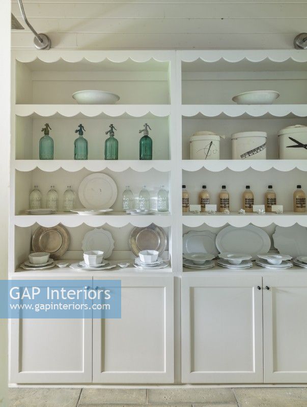 A scalloped edging on the built-in cupboard tips the scales toward nostalgic. 