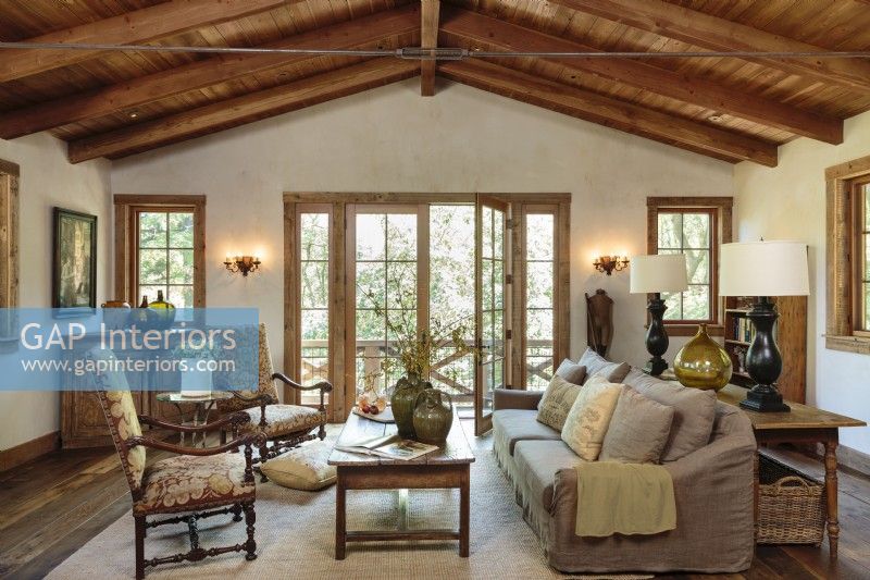 Old redwood beams crown the simply yet visually powerful living room.