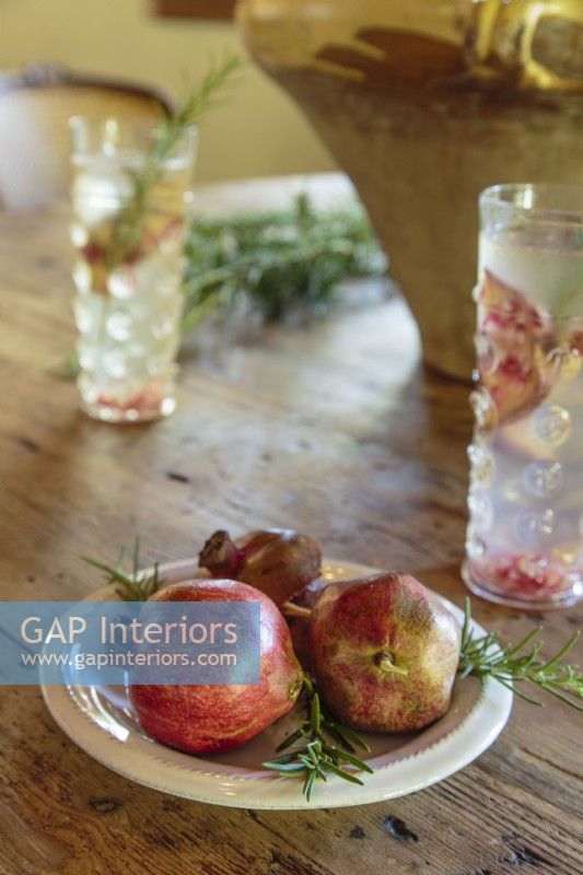 Pomegranates and rosemary have fitting rustic feel.