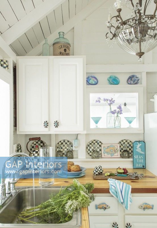 Aqua- blue accents and black and white accents po pop against white woodwork.