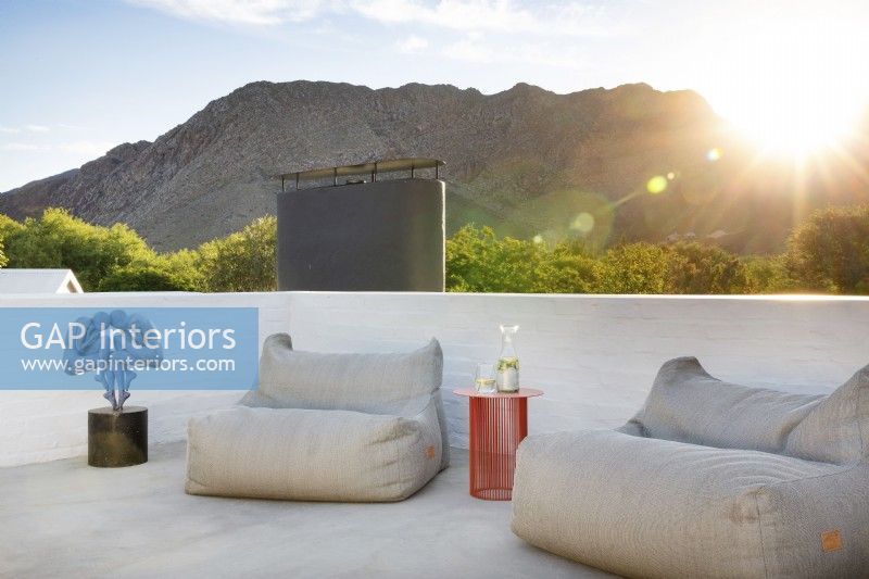 Outdoor furniture on rooftop with mountain views