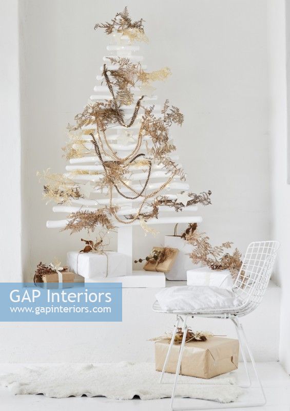 Modern wooden white Christmas tree decorated with natural materials 