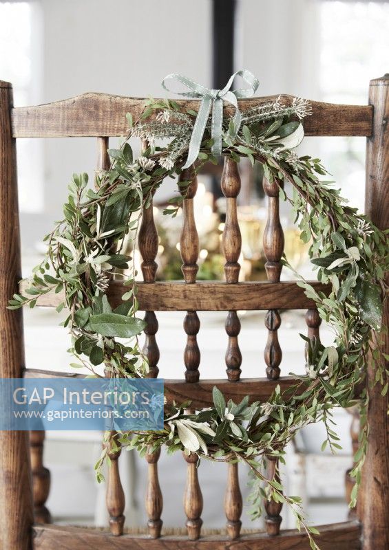 Detail of natural wreath on rustic wooden chair