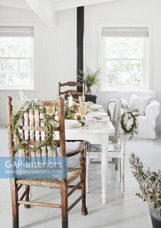 White country dining room decorated with rustic wreaths