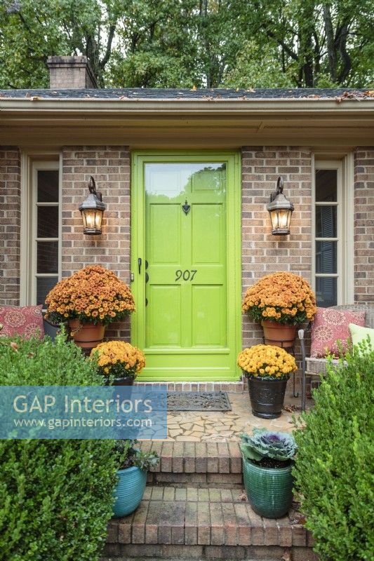 A lime-green door and colorful pots of flowers announce Debbie's love of cheerful hues.