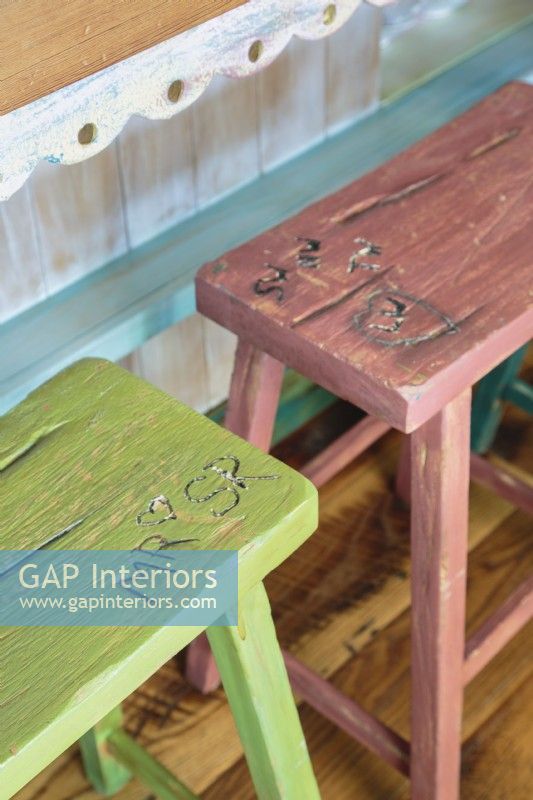 Rw wood stools sport a variety of colors and carved the the children initials.