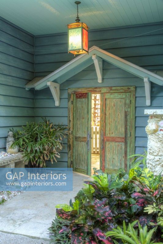 Painted weathered doors open onto to the pool area.