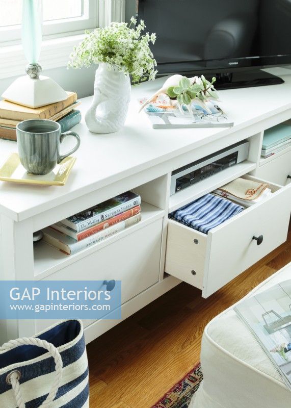 Drawers and cubbies keep linens, board games and books organized and easy to grab.