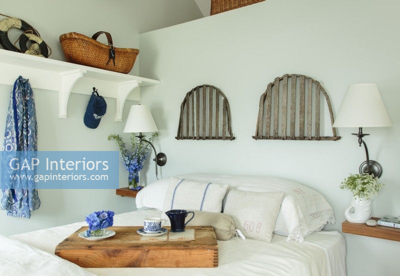 Lobster trap doors function as a headboard, while space saving floating shelves takes place of nightstands. 