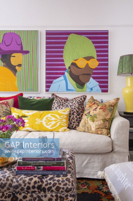 Patterned scatter cushions and colourful art in living room