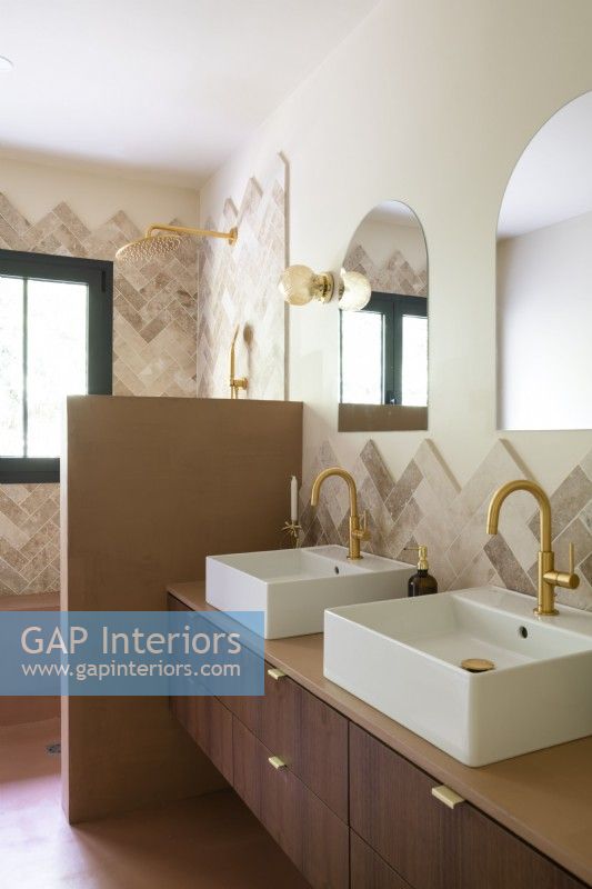 Double sinks with gold taps in retro style bathroom