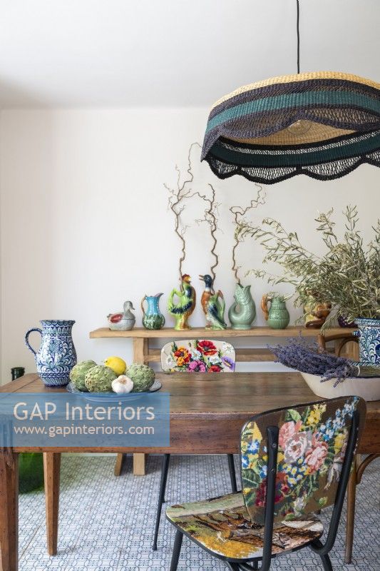 Floral vintage chairs and colourful ceramic collection in dining room