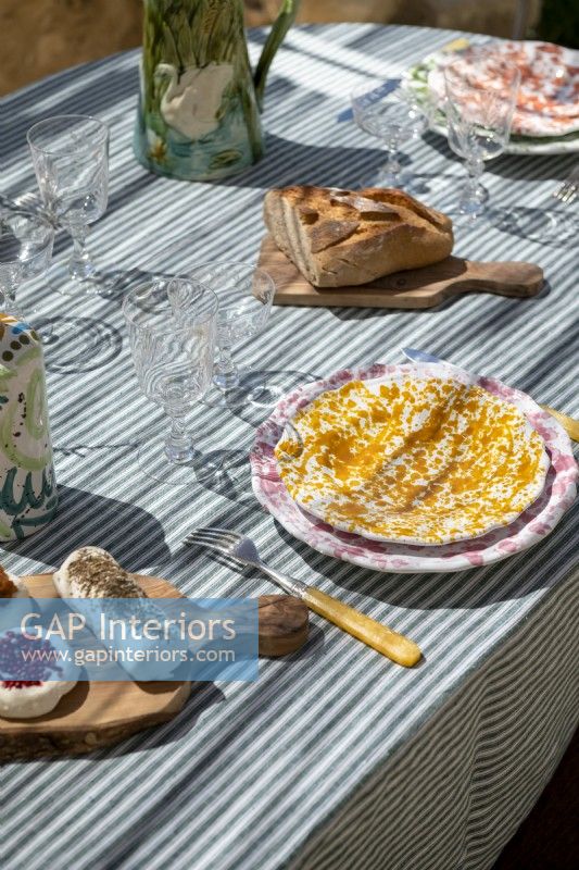 Rustic decorative plates on outdoor dining table - detail