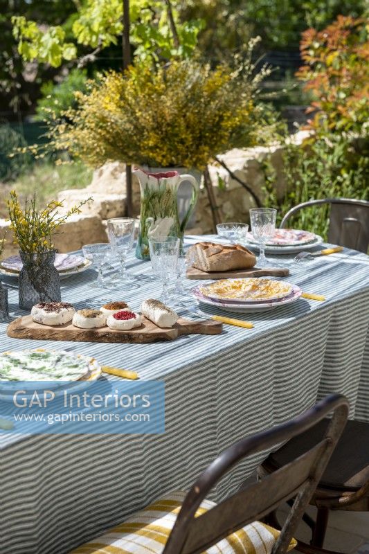 Detail of place settings and food on outdoor dining table