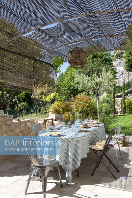 Outdoor dining table on terrace of country home in summer