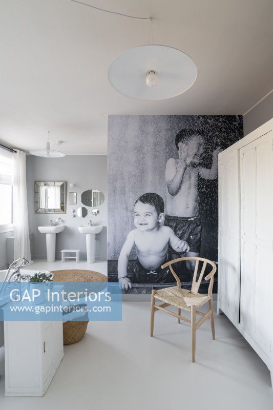 Photograph feature wall in modern white and grey bathroom
