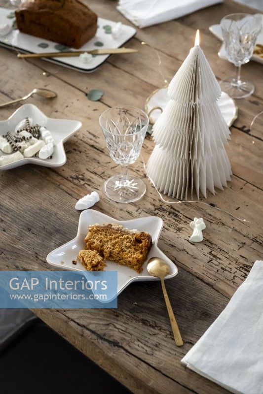 White accessories and Christmas decorations on dining table