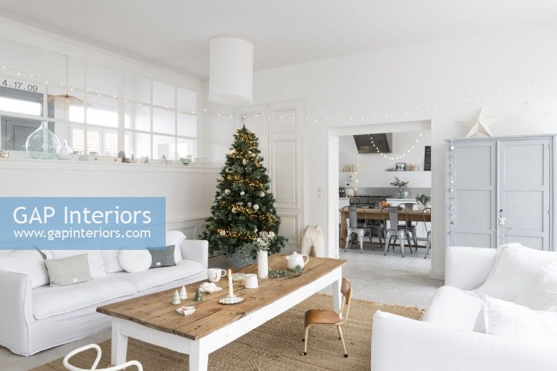 Decorated Christmas tree in white painted living room
