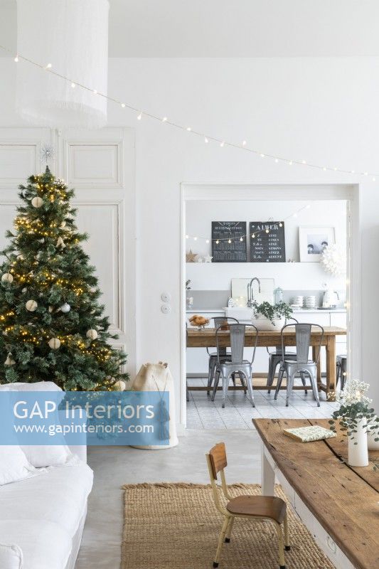Christmas tree in modern country living room with view to kitchen