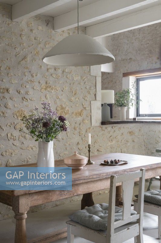 Country dining room with exposed stone wall